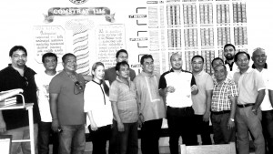 Reelectionist Rep. Erico Aristotle Aumentado (1st district) is holding a copy of his certificate of candidacy (COC), the first to file in Bohol on Monday, with provincial election officer lawyer Eliseo Labaria and some members of his family. - Photo by Leo Udtohan
