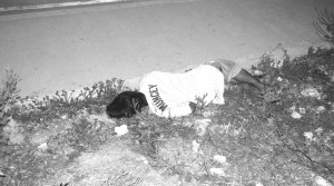 EX-CONVICT.  Lifeless body of Raymund Alising, 24, lies along the road after he was gunned down past 9:20last night near the Central Market.