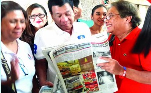 PRESIDENTIAL race leader Mayor Rodrigo Duterte shares light moment in reading The Bohol Chronicle with senior writer Chito Visarra during the former's last visit to Bohol.