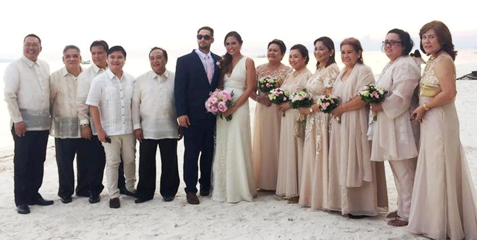The newlyweds with their principal sponsors right at the white sandy shore of South Palms Resort