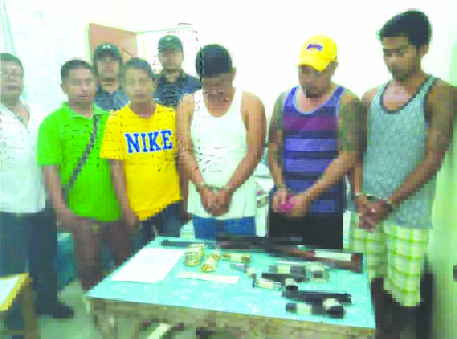 ONE IN, TWO AT LARGE. Fernando Sigue together Alvin Paradini and Lordan Balangit presented to the media after their arrest for illegal prossession of firearms last Monday while Sigue brothers Ryan and Renee remain at large. Assorted firearms were also seized. P1million cash found in Renee's bed during the search at his residence.