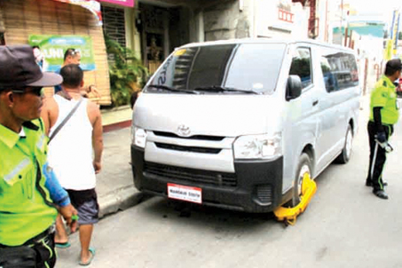 Photo above shows CTMO personnel testing the wheel clamps on a vehicle as part of   their Public Information campaign before its implementation on Sept. 1, 2016.  